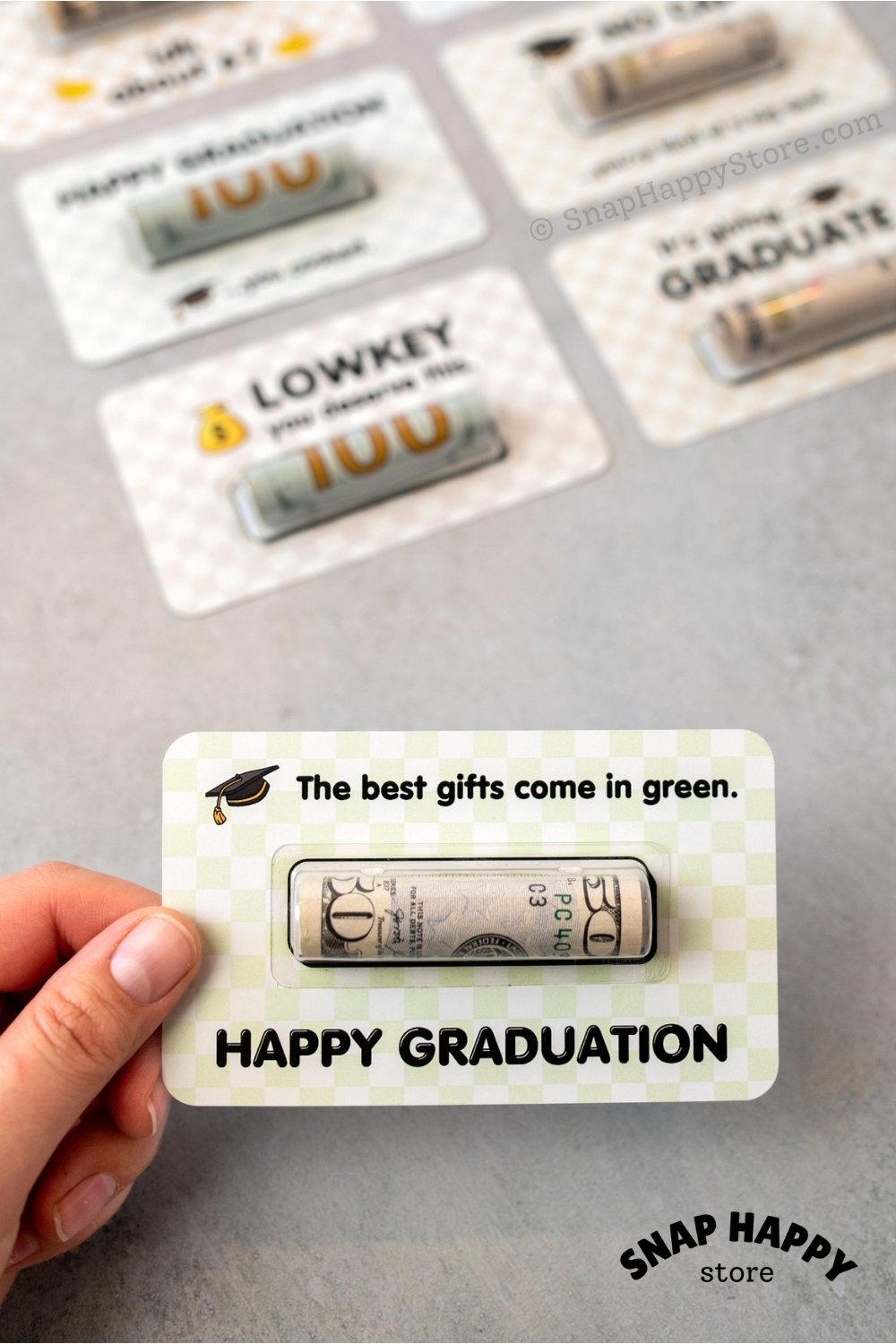 fp:50% 80% | Graduation-themed gift card held by a hand with 'Happy Graduation' text on a gray background.