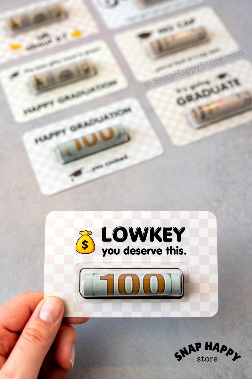 fp:50% 80% | Graduation card with 'LOWKEY you deserve this' text, held by a hand.